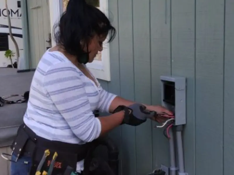 Licensed electrician wiring an exterior subpanel in Rio Communities